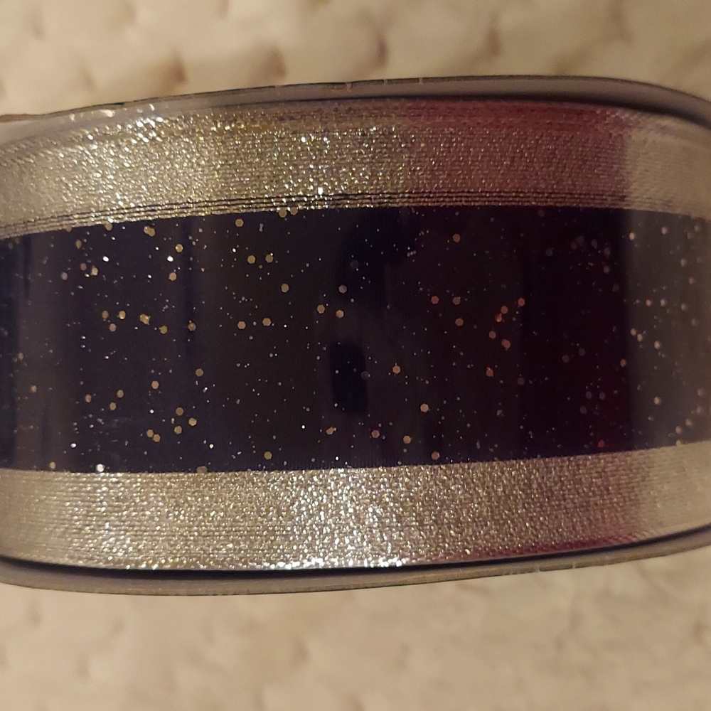50 yards - 2.5 " wide sparkly black and silver holiday ribbon.